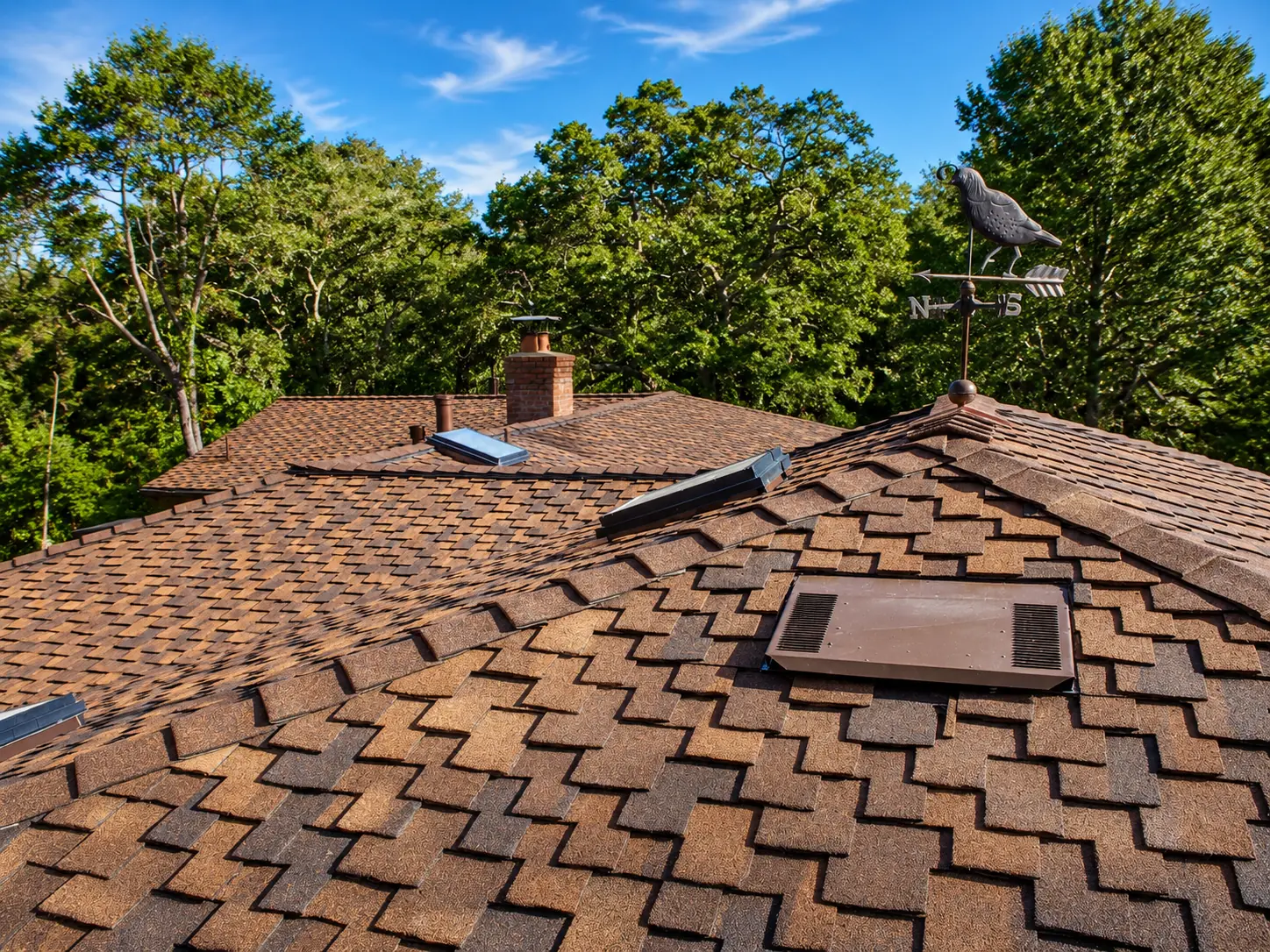Re-roofing project under clear blue skies by Dynamite Roofing